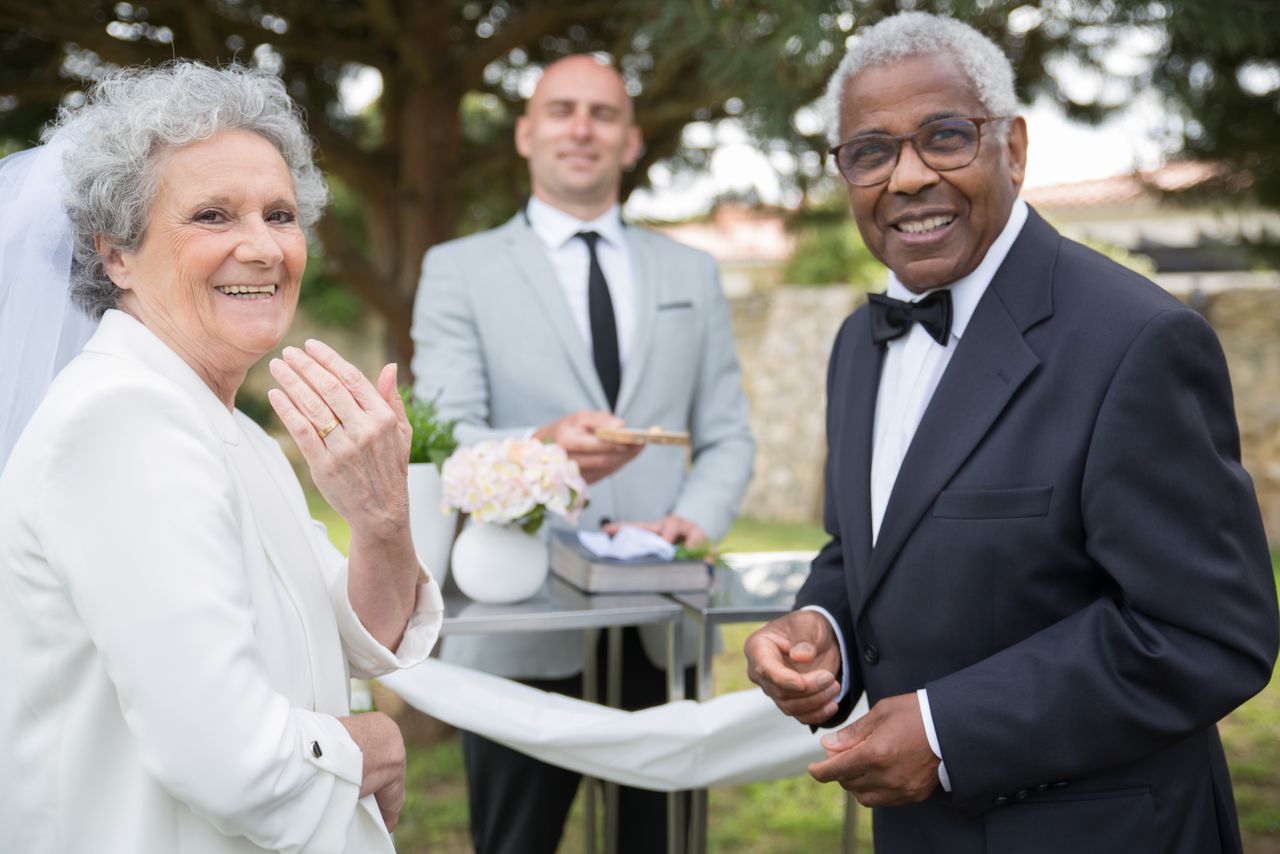 Happy senior couple celebrating their outdoor wedding ceremony.